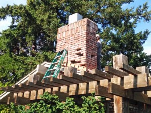 The chimney at the front of the house had many loose and damaged bricks.