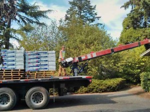 A conveyor truck arrived and delivered shingles to the roof.