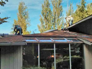 Work started with tearing off the old roofing from the rear of the house.